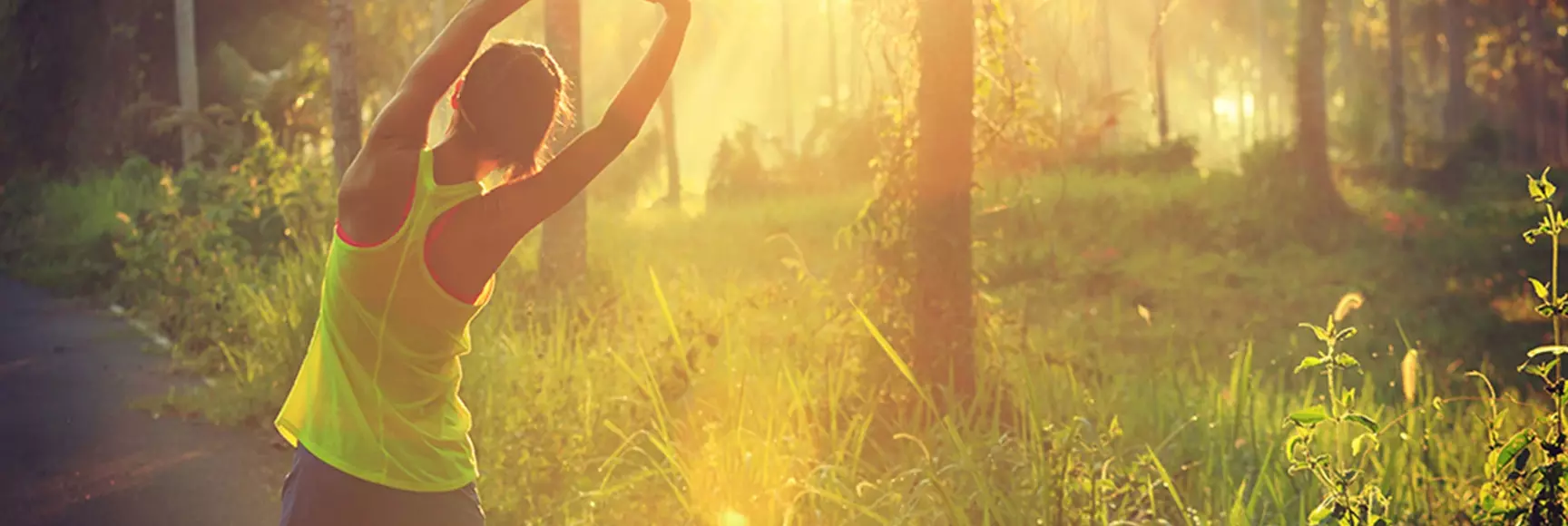 A female jogger in nature wears sustainable garments made with recycled materials and durable fibers that extend its lifespan